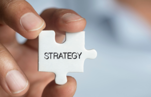  A close-up of a puzzle piece labeled "Strategy," representing a well-structured approach to investment planning, tax efficiency, and wealth management in Upstate South Carolina.
