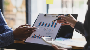 A professional in Anderson County, SC reviews investment papers, analyzing market trends and risk management strategies for retirement and portfolio growth.
