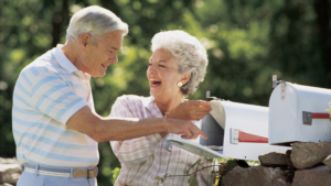 Smiling couple opening mailbox to check for tax refund check – financial planning concept with BCA Private Wealth